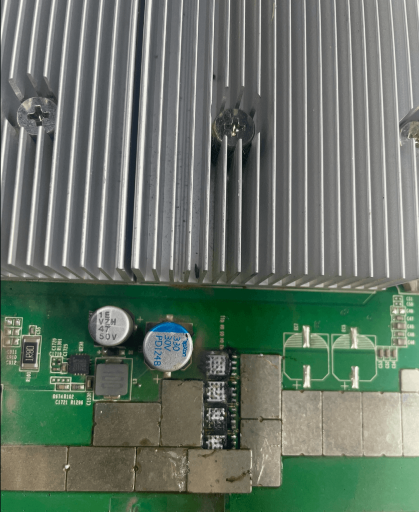 Close-up of an Antminer S19 hashboard showing a temporary MOSFET repair using a glowing solder bridge to bypass a burnt component, highlighting the 5-minute emergency fix.